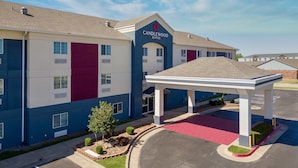 A multi-story hotel with a prominent entrance and a covered outdoor area.