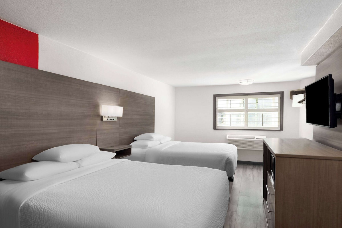 pillow-top beds, desk, laptop workspace, blackout curtains