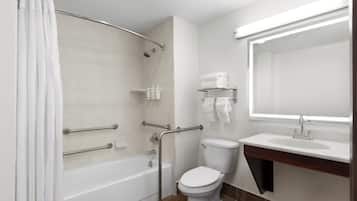 A modern bathroom with a bathtub, toilet, and sink.