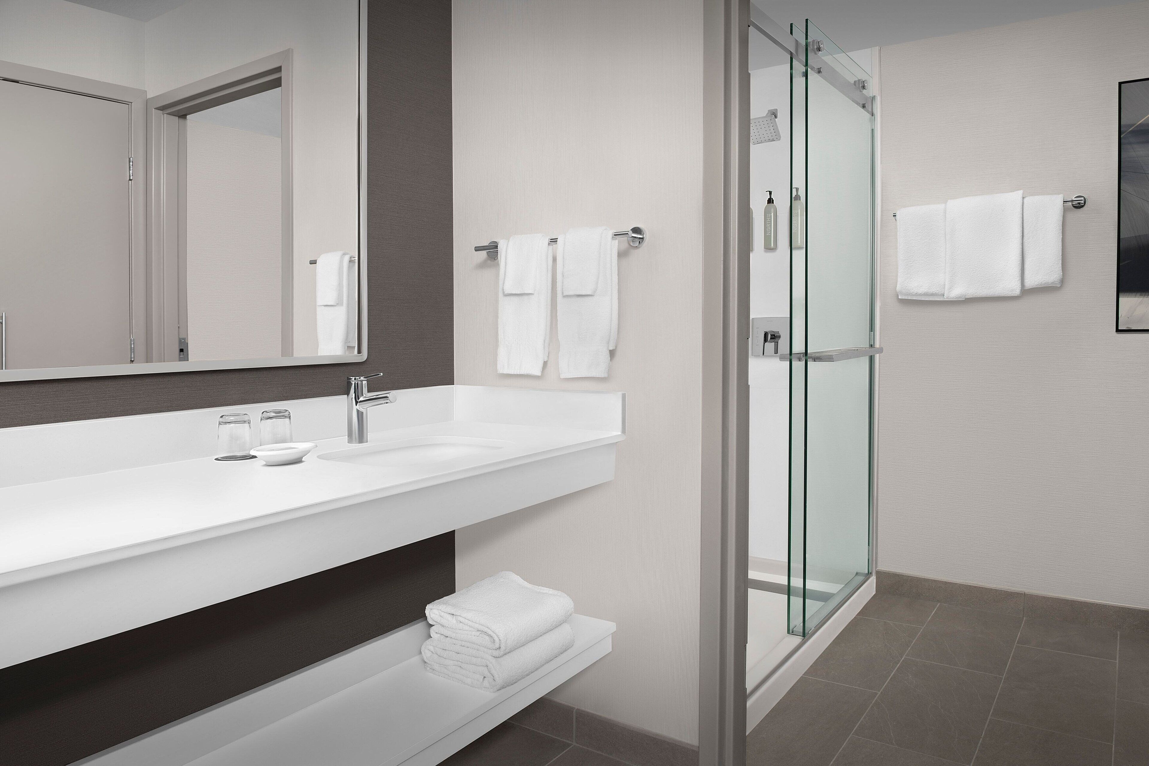 combined shower/bathtub, designer toiletries, hair dryer, towels