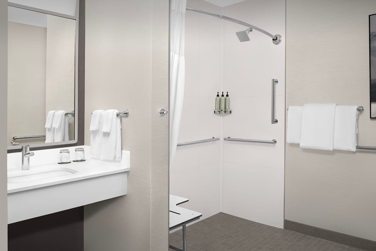 Combined shower/tub, designer toiletries, hair dryer, towels