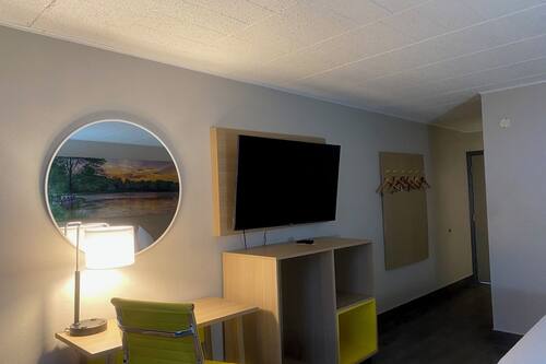 Desk, laptop workspace, blackout drapes, iron/ironing board