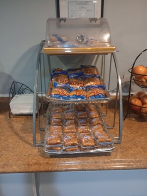 A buffet setup with trays of Hostess Honey Bites and Hostess Coffee Cakes.