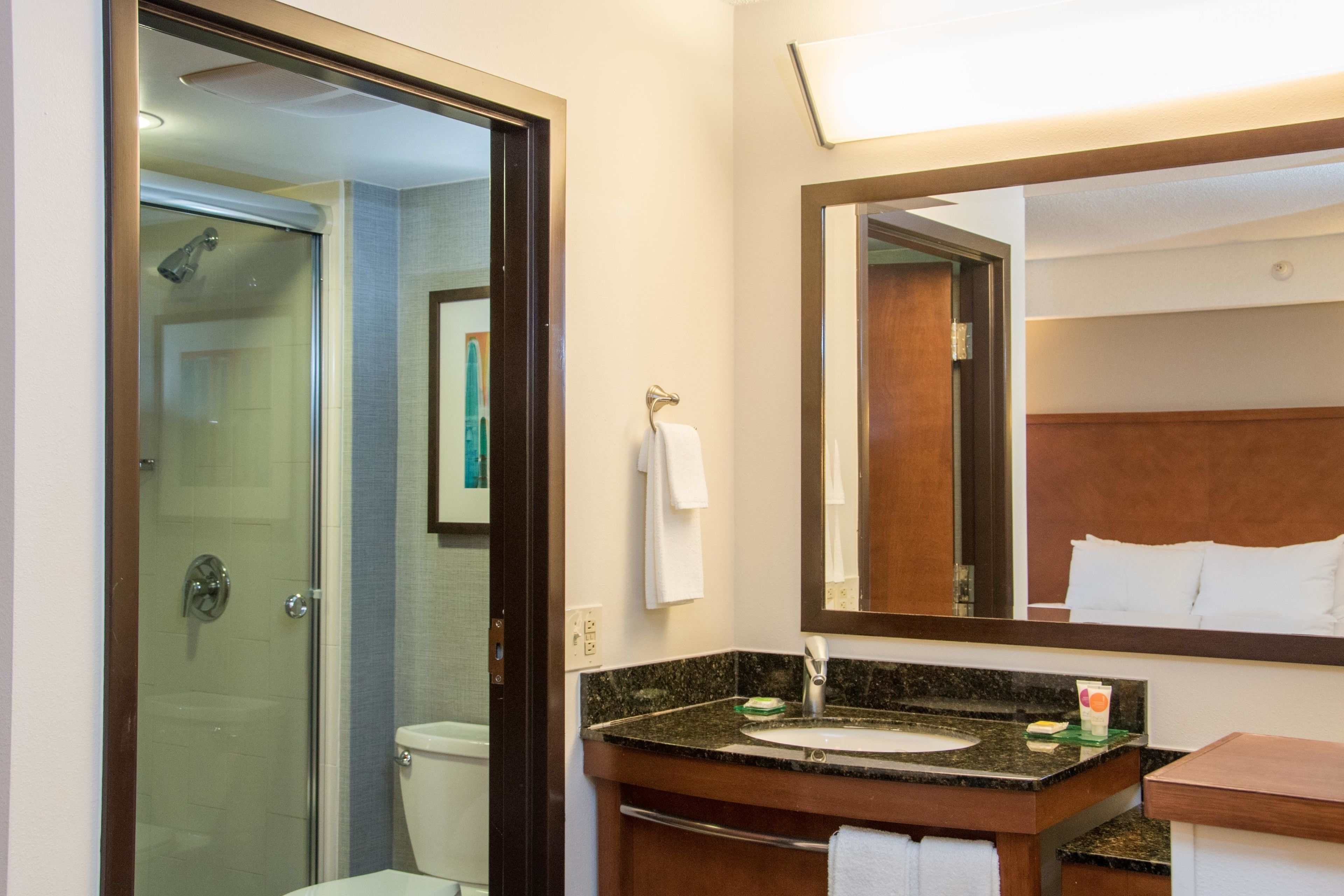 combined shower/bathtub, designer toiletries, hair dryer, towels