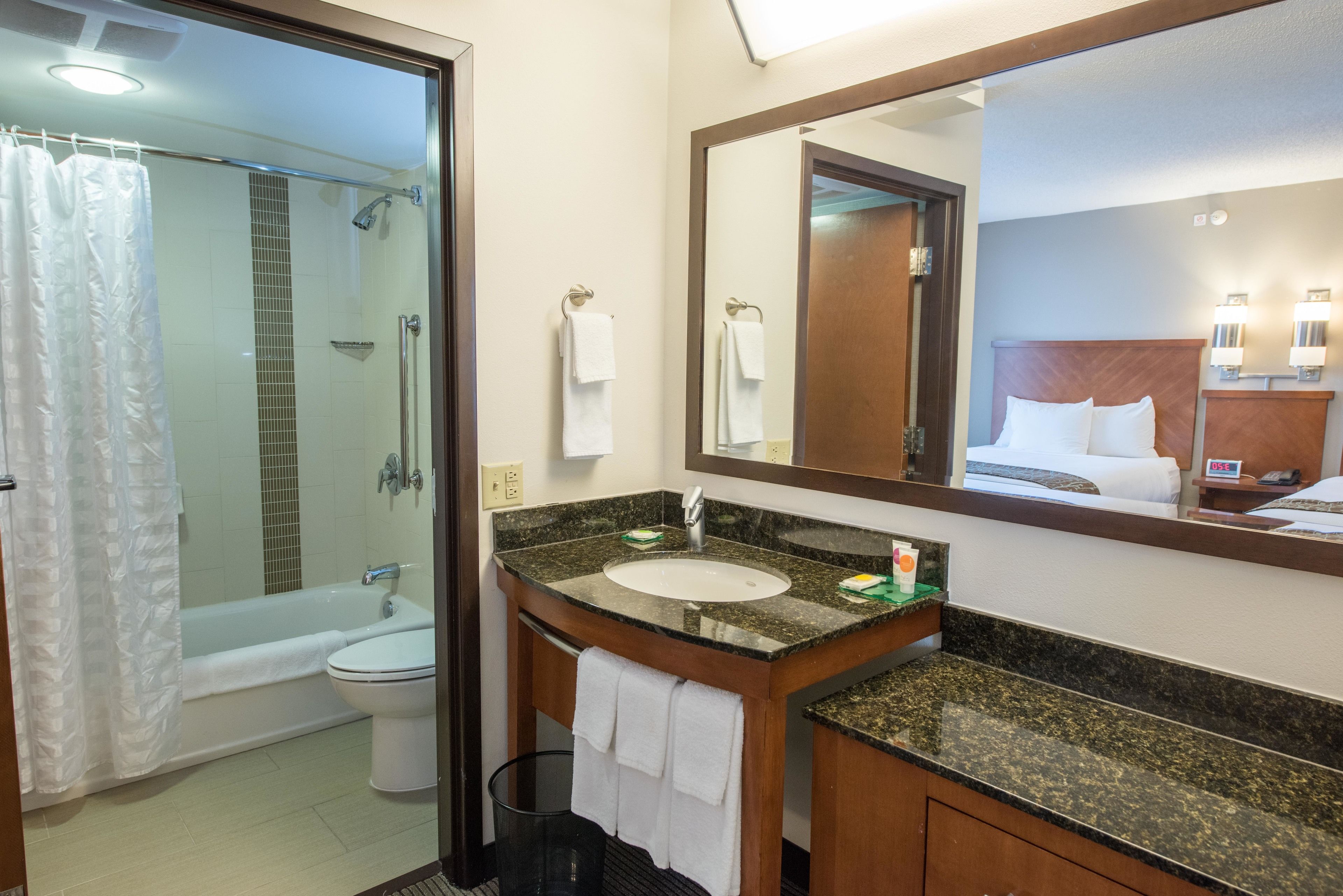 combined shower/bathtub, designer toiletries, hair dryer, towels