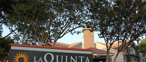 A hotel sign with the name "LA QUINTA BY WYNDHAM" and a sun logo.