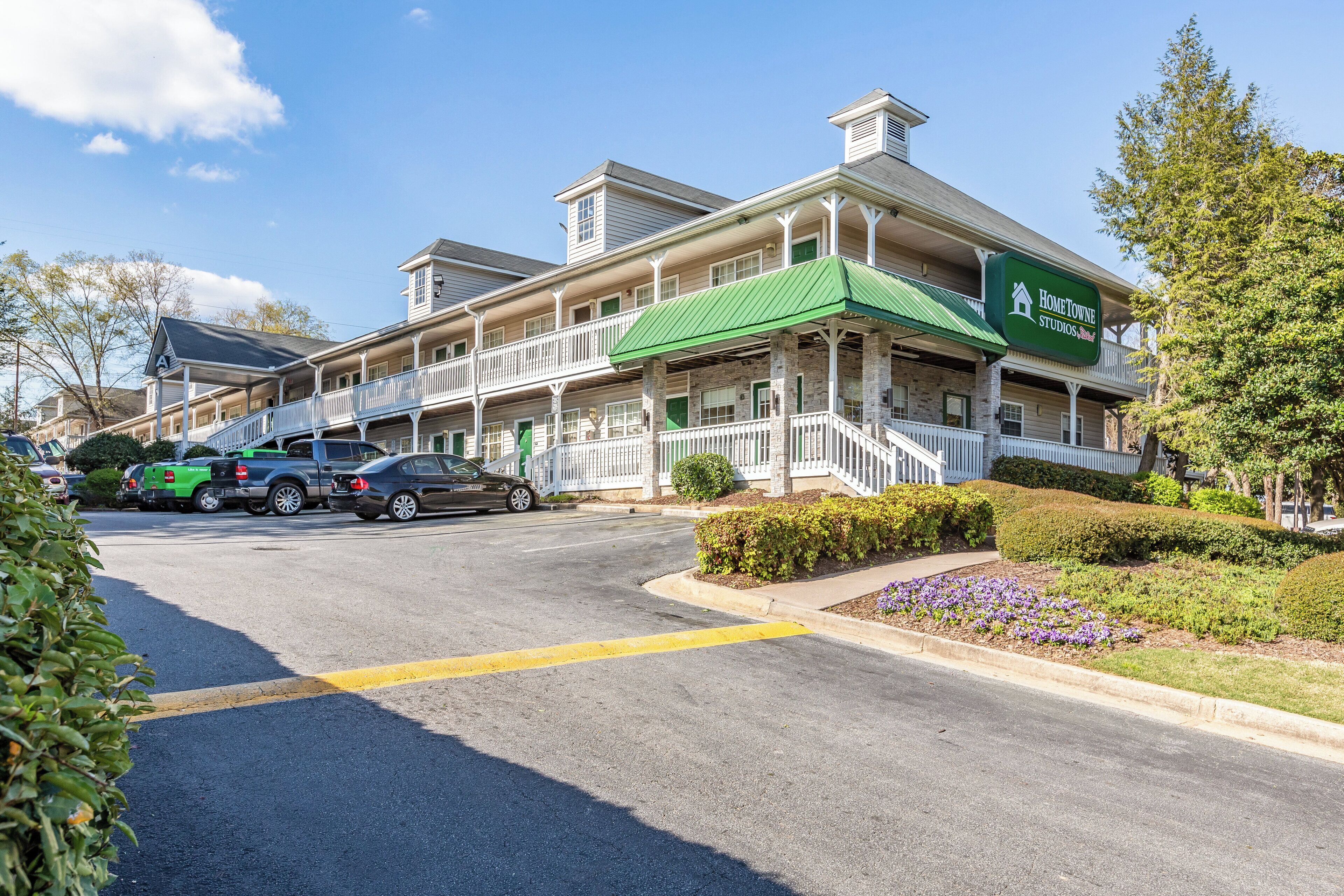 A two-story building with a green awning and a sign for 'Home Towne Studios.'