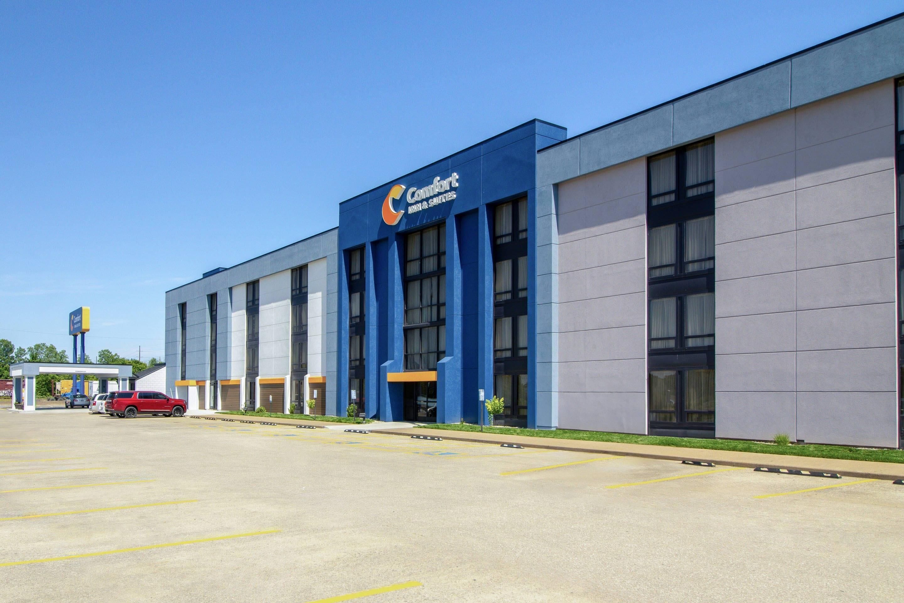 A modern building with a blue facade and large windows, likely a hotel or business center.