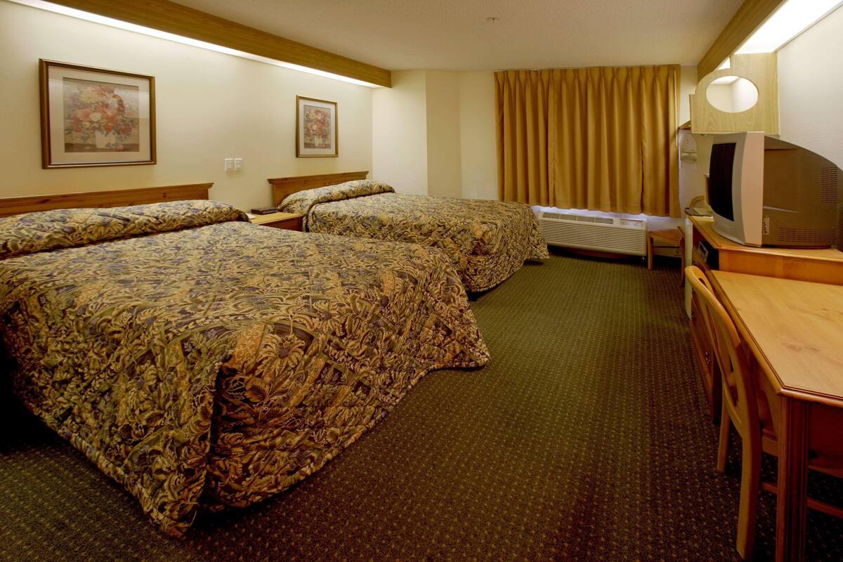 Premium bedding, desk, laptop workspace, blackout curtains