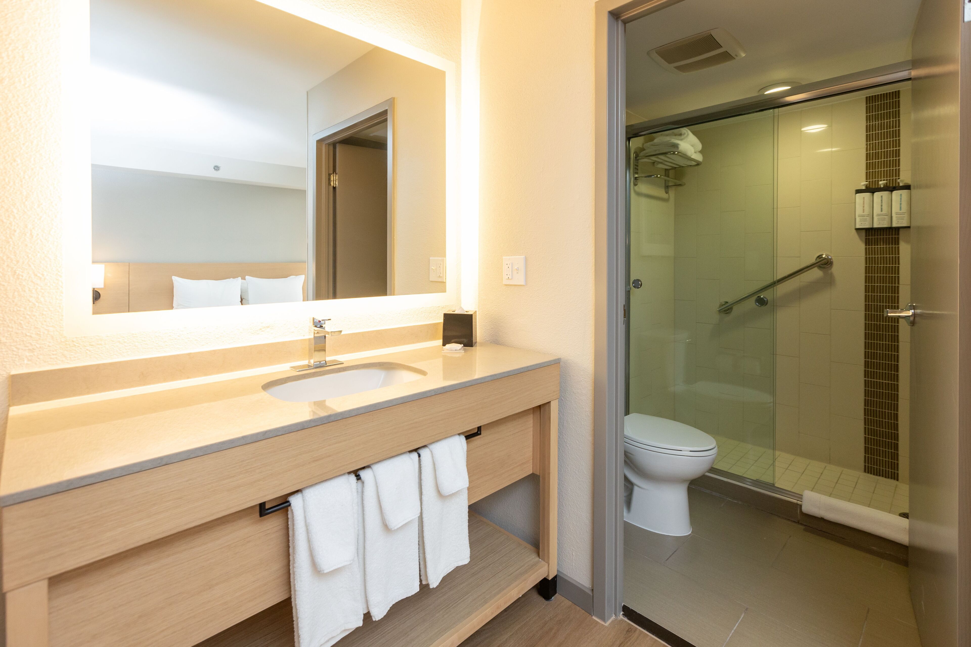 combined shower/bathtub, designer toiletries, hair dryer, towels