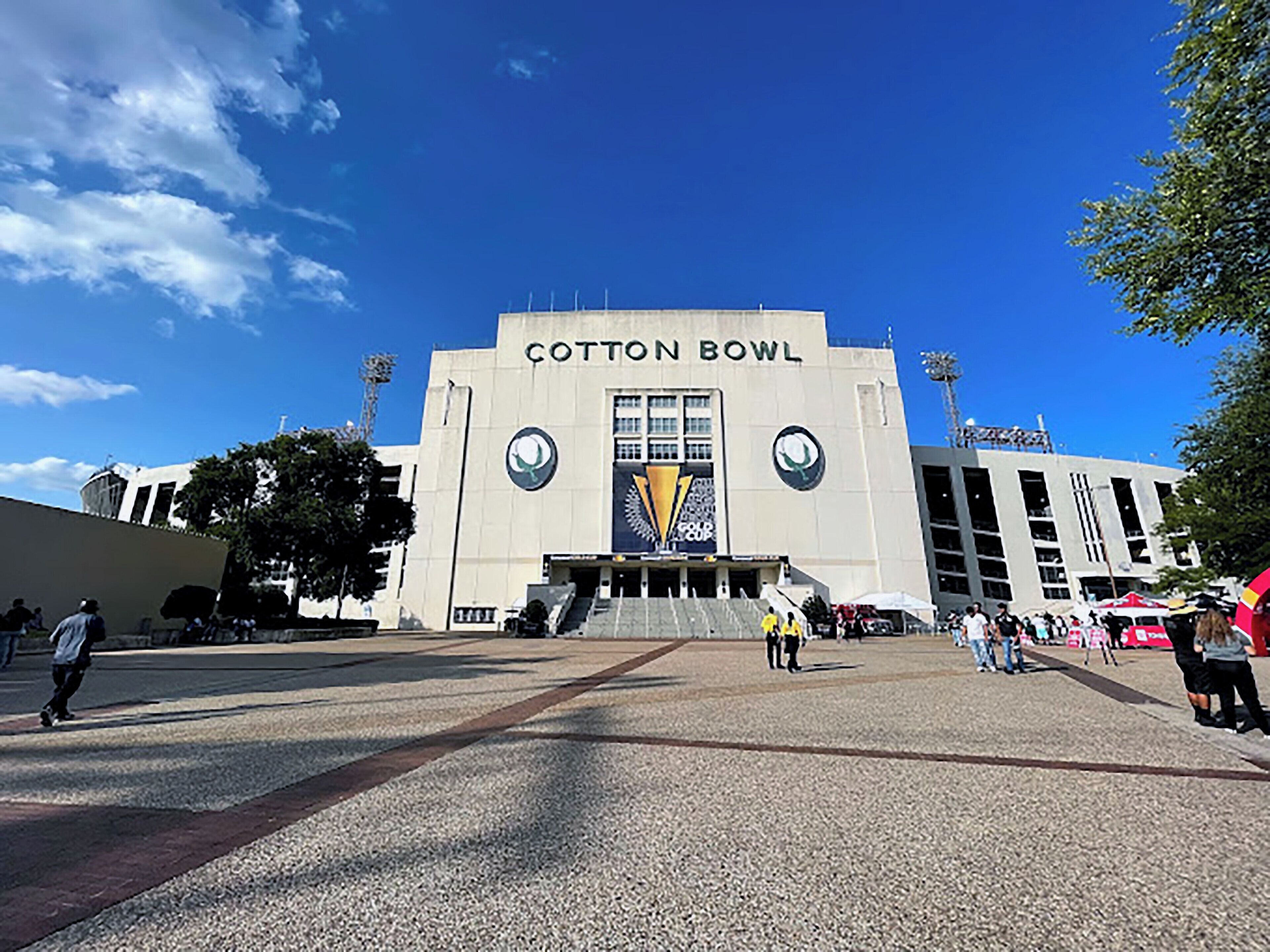 A large, modern building with the sign "COTTON BOWL" prominently displayed.