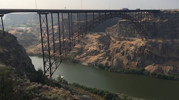 A large steel bridge spanning a deep canyon with a river below.