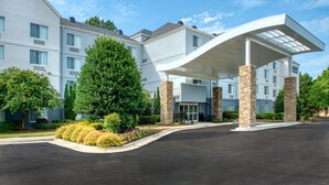 A modern hotel with a covered entrance, multiple floors, and a landscaped driveway. - Fairfield Inn By Marriott Raleigh Crabtree (Raleigh)