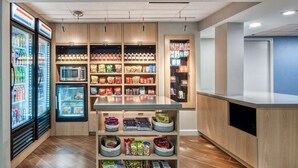 A self-service kiosk with refrigerated beverages, microwaves, and shelves stocked with snacks and packaged goods. - Fairfield Inn By Marriott Raleigh Crabtree (Raleigh)