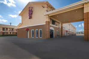 Welcome to the Red Roof Inn, featuring a flat roof with a covered entrance and parking area.