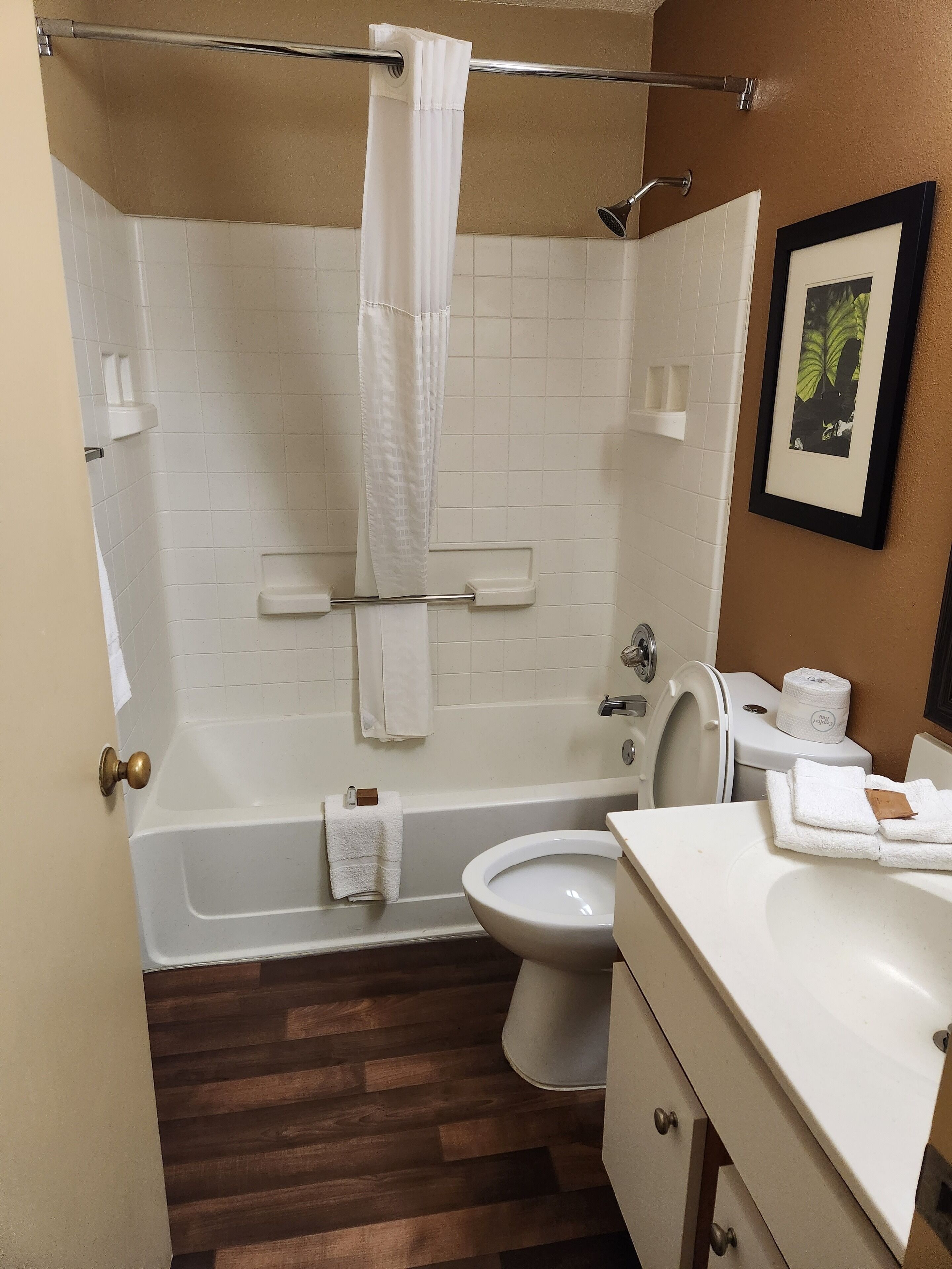 A bathroom with a bathtub, toilet, and sink.