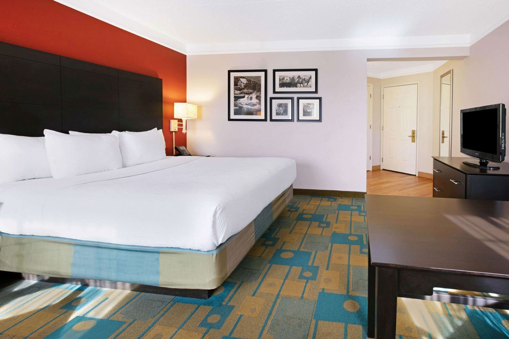 Premium bedding, desk, laptop workspace, iron/ironing board