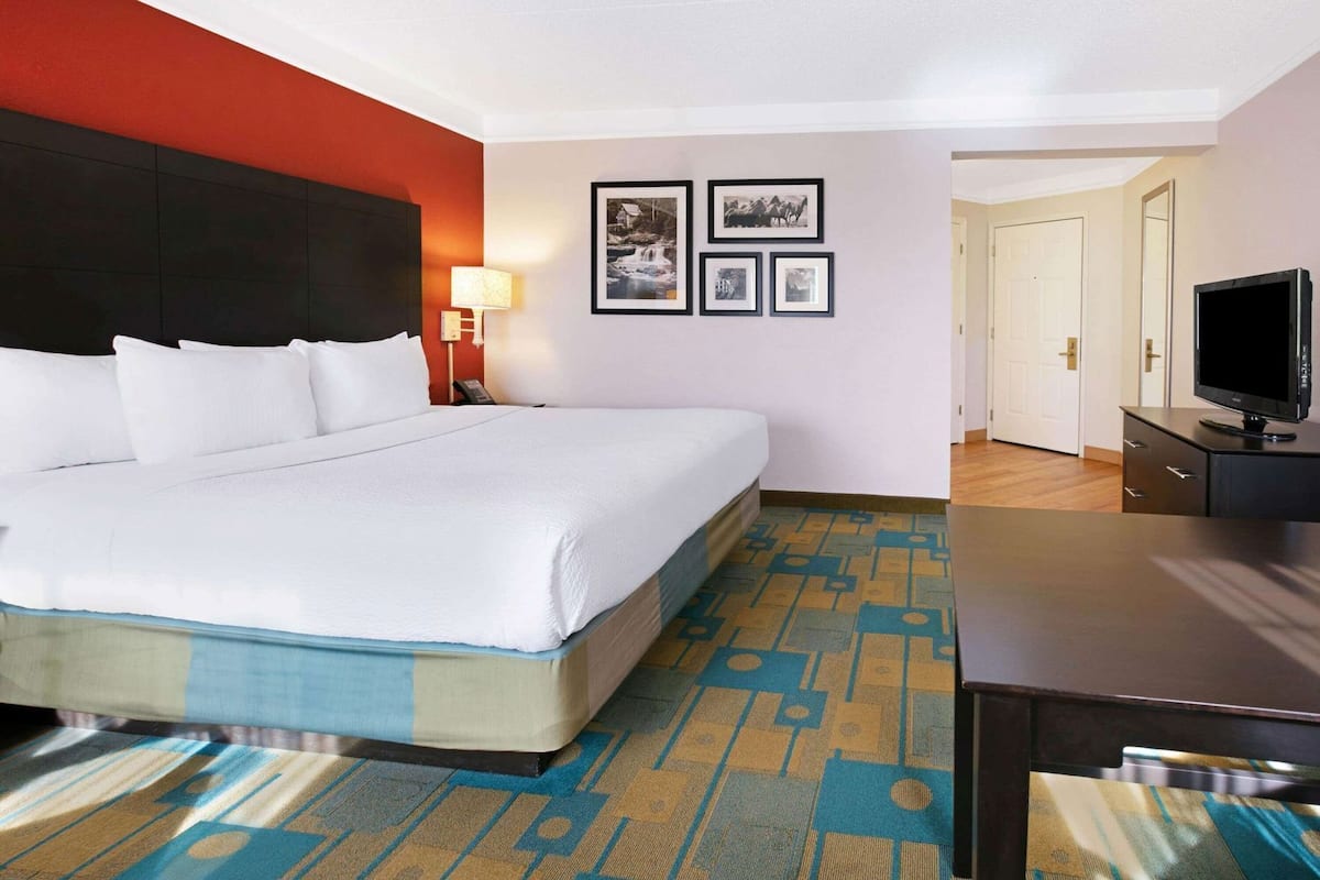 Premium bedding, desk, laptop workspace, iron/ironing board