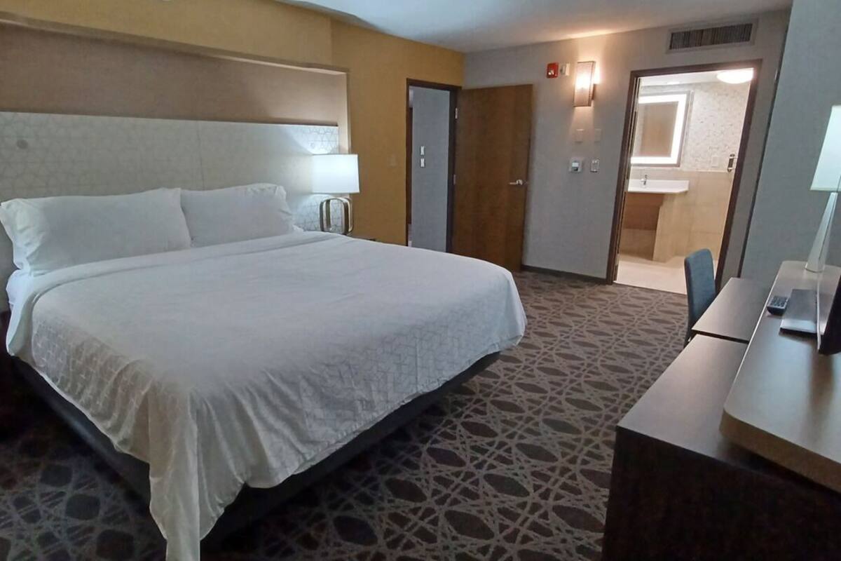 suite, 1 king bed, hearing accessible | desk, iron/ironing board, free cots/infant beds, free wifi