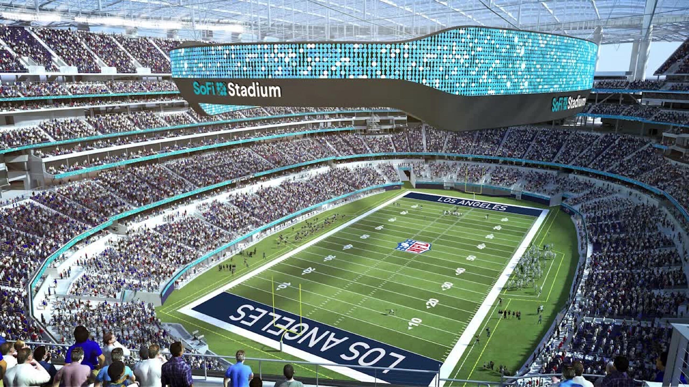 A stadium with multiple tiers of seating, a large field marked with team logos, and a prominent SoFi Stadium sign.