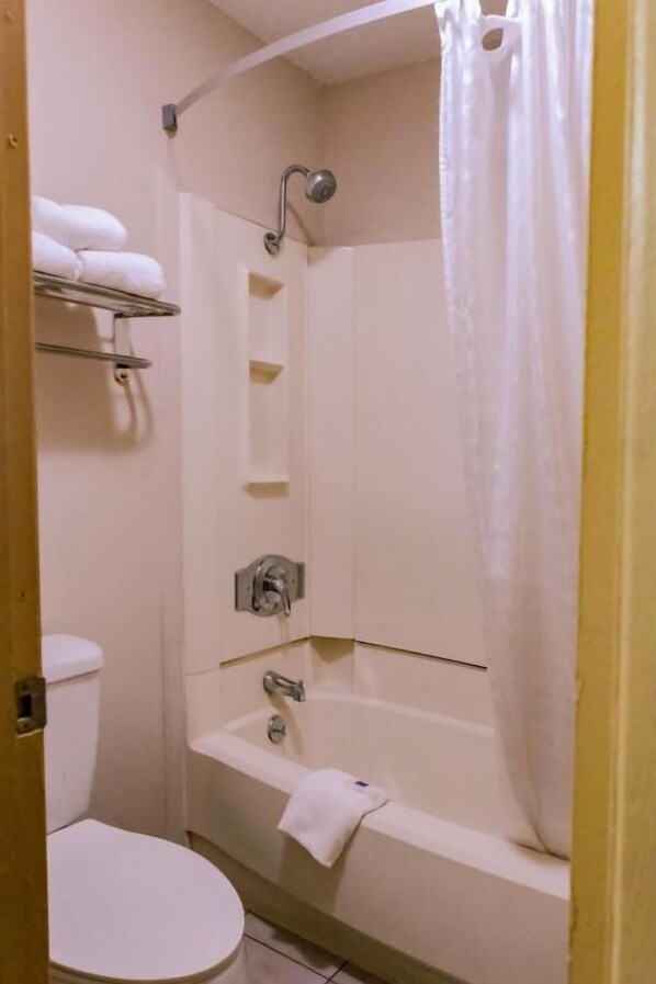A bathroom with a toilet, a bathtub, and a shower. - Motel 6 Nacogdoches TX (Nacogdoches)