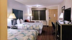 A hotel room with two beds, a desk, a chair, a TV, and a window with curtains. - Motel 6 Nacogdoches TX (Nacogdoches)