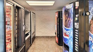 A hallway with vending machines, including Pepsi, and a brick wall. - Motel 6 Danvers, MA - Boston North (Danvers)