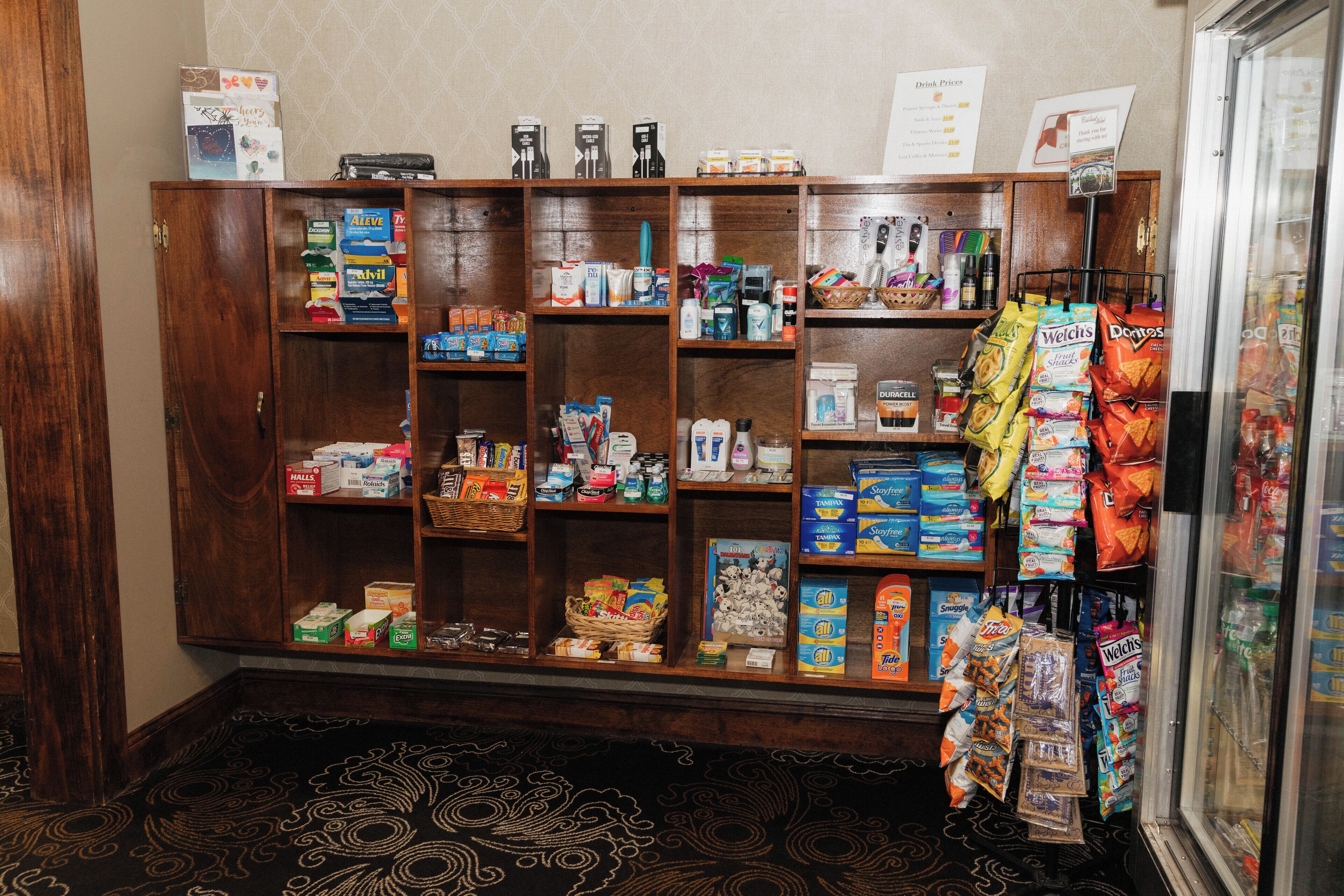 A pantry stocked with various food items and snacks, including boxes of cereal, snacks, and beverages.