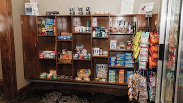 A pantry stocked with various food items and snacks, including boxes of cereal, snacks, and beverages.