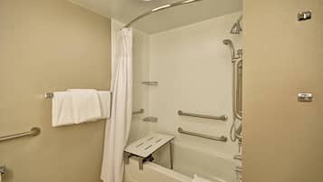 A modern bathroom with a walk-in shower, grab bars, a towel rack, and a shower curtain.