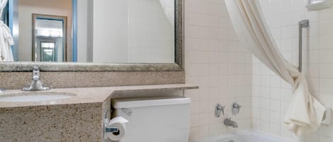 A bathroom with a sink, toilet, and bathtub.