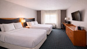A hotel room with two beds, a desk, a TV, and a window with curtains. - Comfort Inn & Suites Texas City I-45 (Texas City)