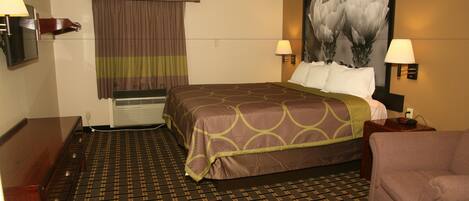 A hotel room with a bed, two bedside lamps, a nightstand, a chair, a large painting, a window with curtains, and a patterned carpet.