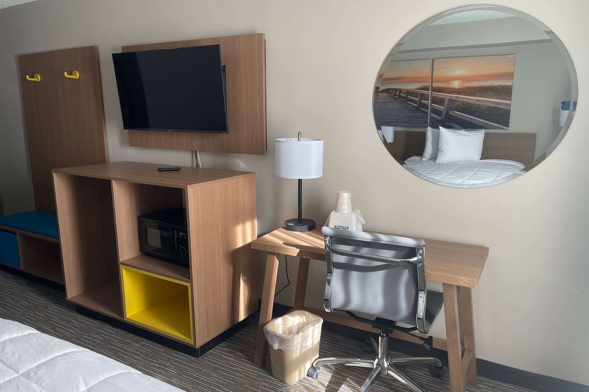Desk, laptop workspace, blackout drapes, iron/ironing board