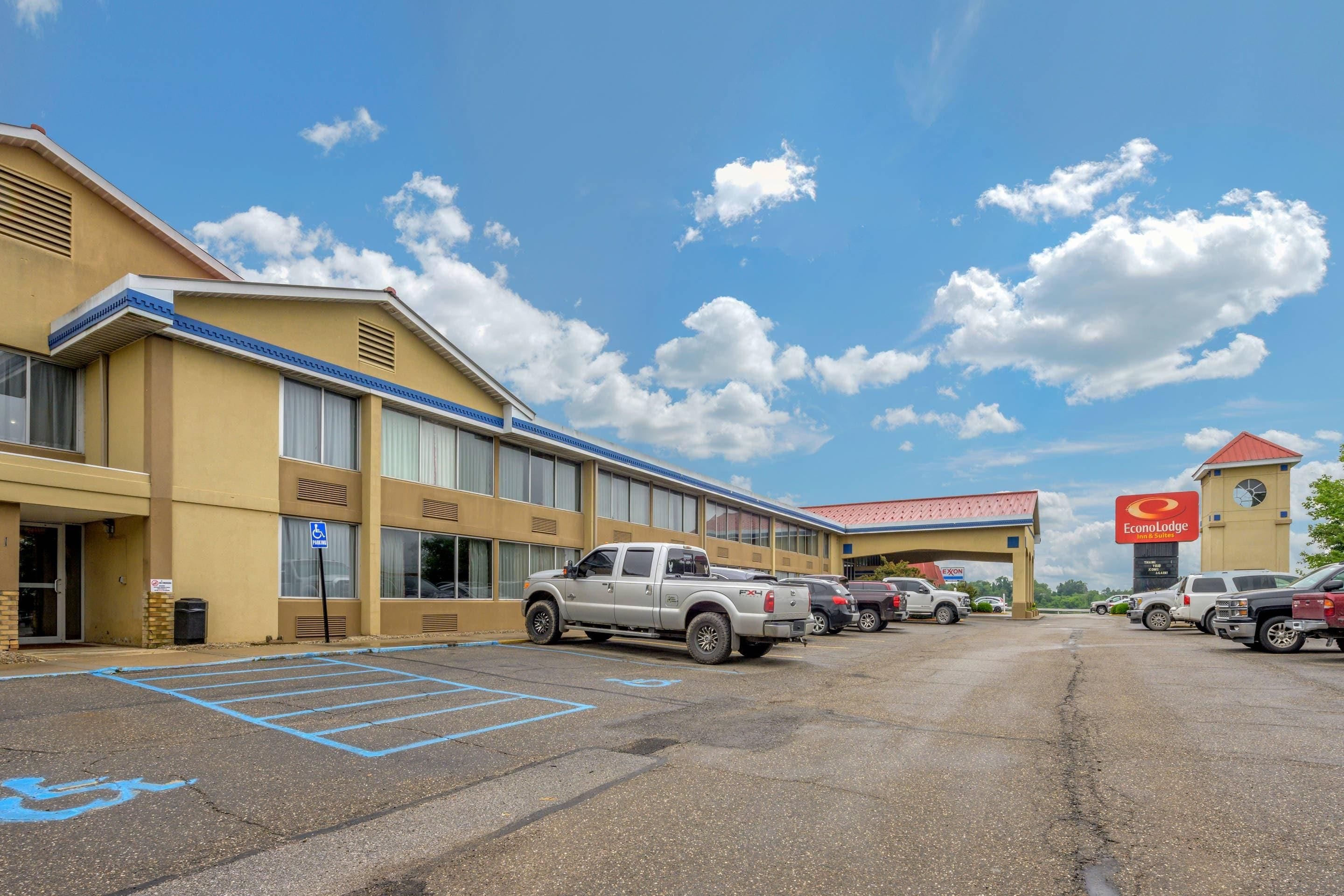 A hotel with a parking lot, a handicapped accessible parking space, and a visible EconoLodge sign.