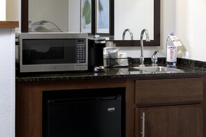 A compact kitchen with a microwave, coffee maker, sink, and dishwasher. - Hyatt Place Richmond/Arboretum (Richmond)