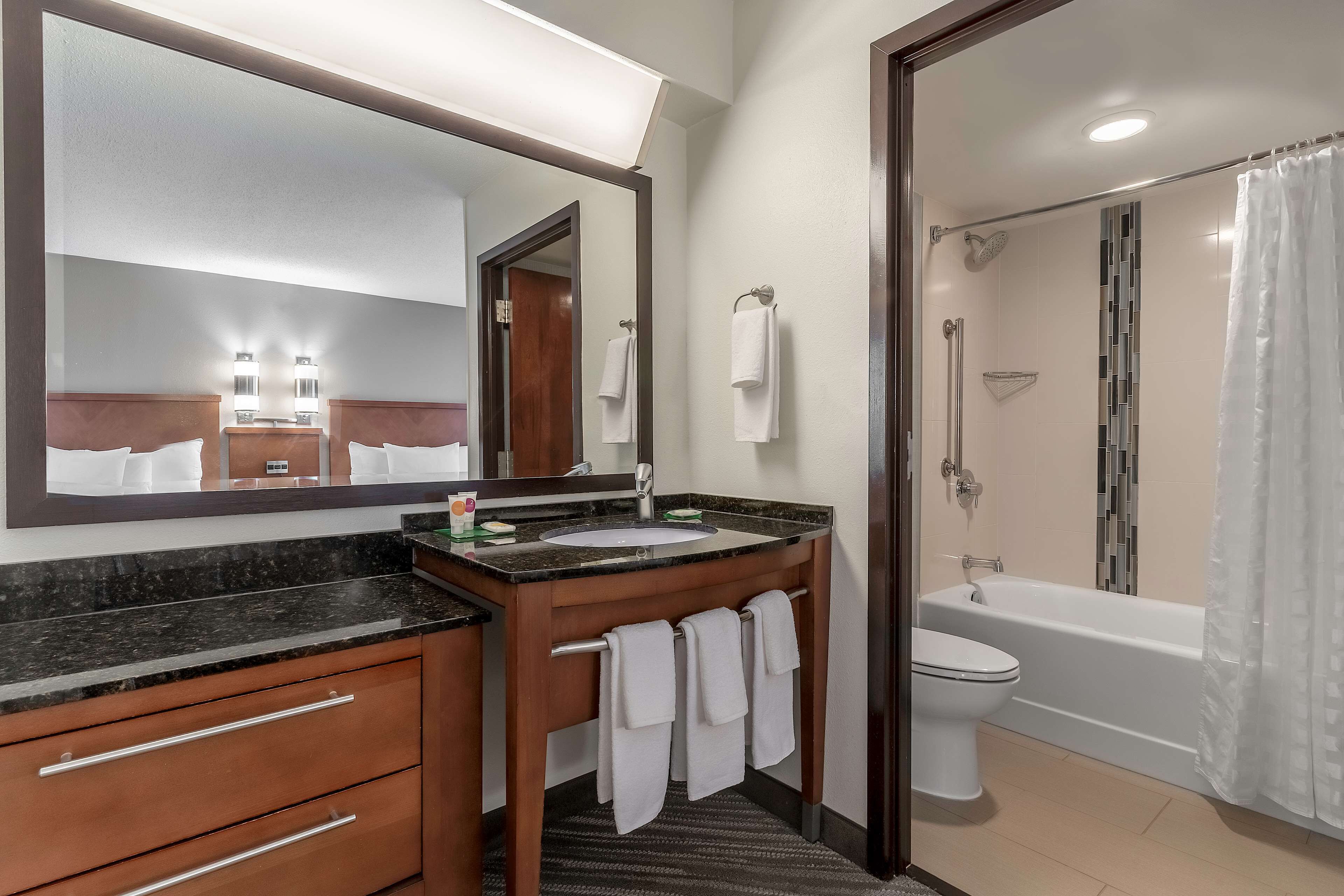 combined shower/bathtub, designer toiletries, hair dryer, towels