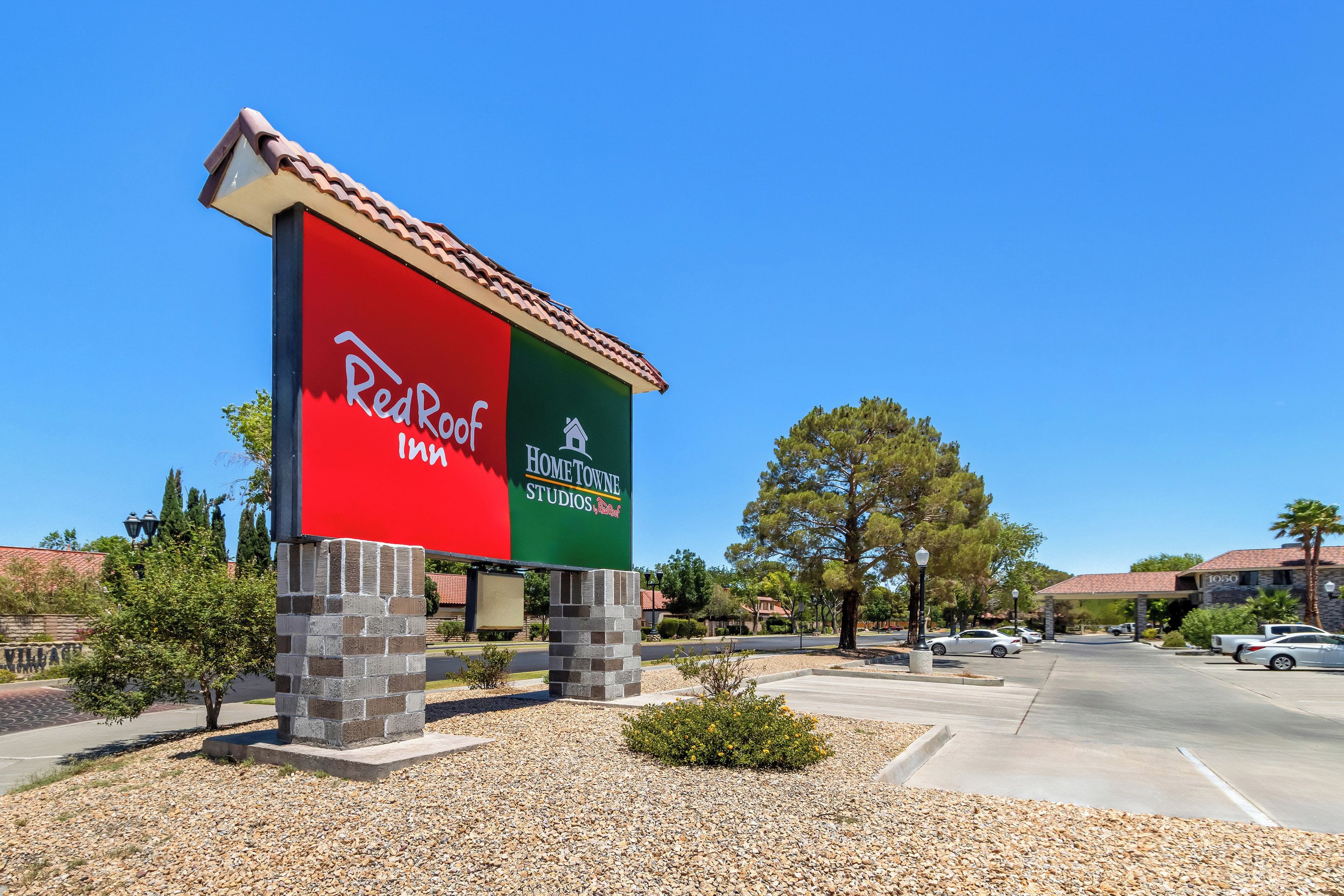 A RedRoof Inn sign with a clear view of the parking lot and surrounding buildings.