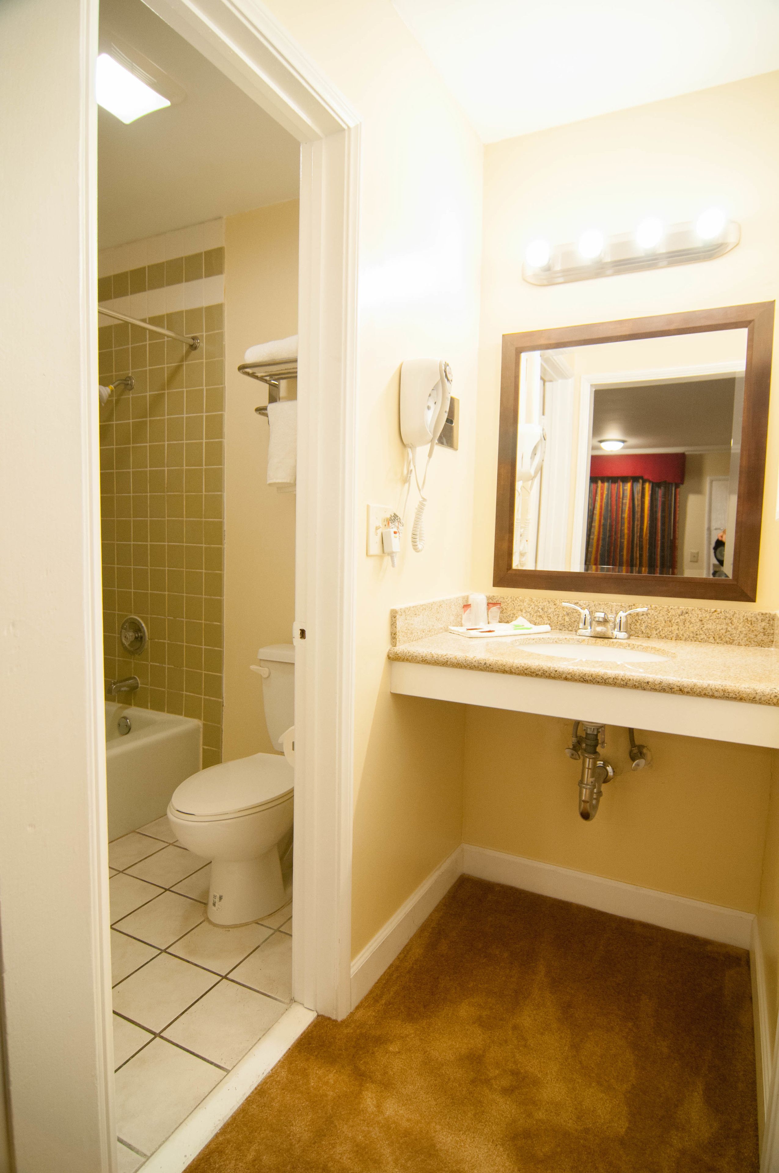 A bathroom with a toilet, sink, and shower.