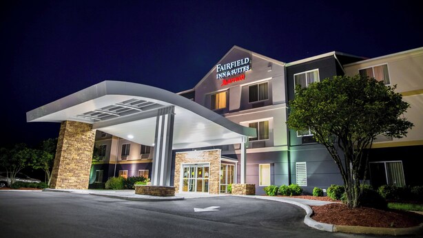 Un hotel moderno a più piani, con ingresso coperto e una segnaletica ben visibile per Fairfield Inn & Suites Marriott.