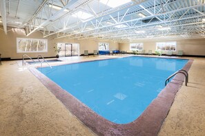 An indoor swimming pool with a high ceiling and large windows. - Days Inn by Wyndham Plattsburgh (Plattsburgh)