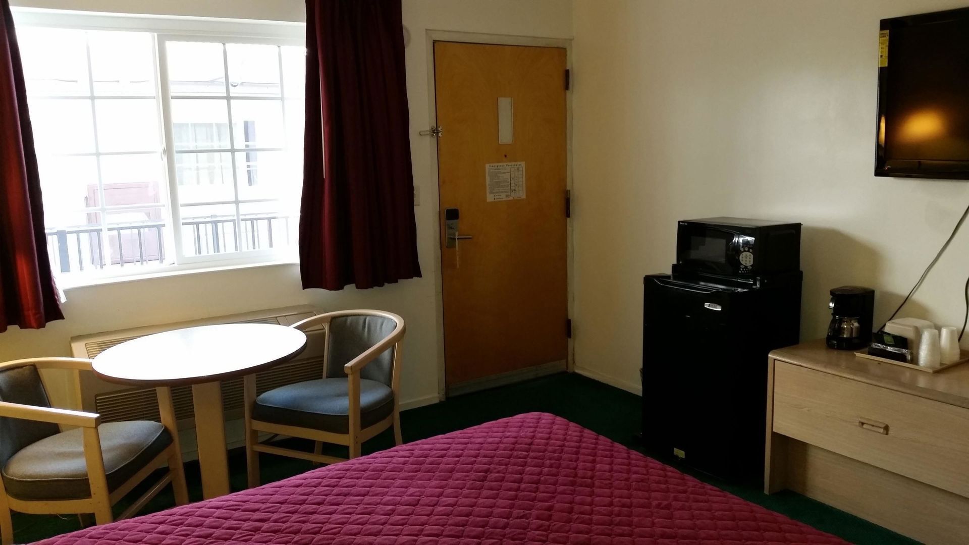 Desk, laptop workspace, blackout drapes, iron/ironing board