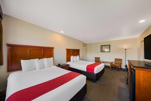A hotel room with two beds, a desk, a chair, a TV, and a minibar. - Rodeway Inn South San Francisco Airport (South San Francisco)