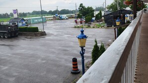 A covered outdoor area with a concrete floor, a blue street lamp, and a traffic cone. - Knights Inn Lindsay (Kawartha Lakes)