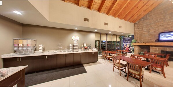 Relax in our welcoming lobby, featuring a reception area with a digital sign and comfortable seating.
