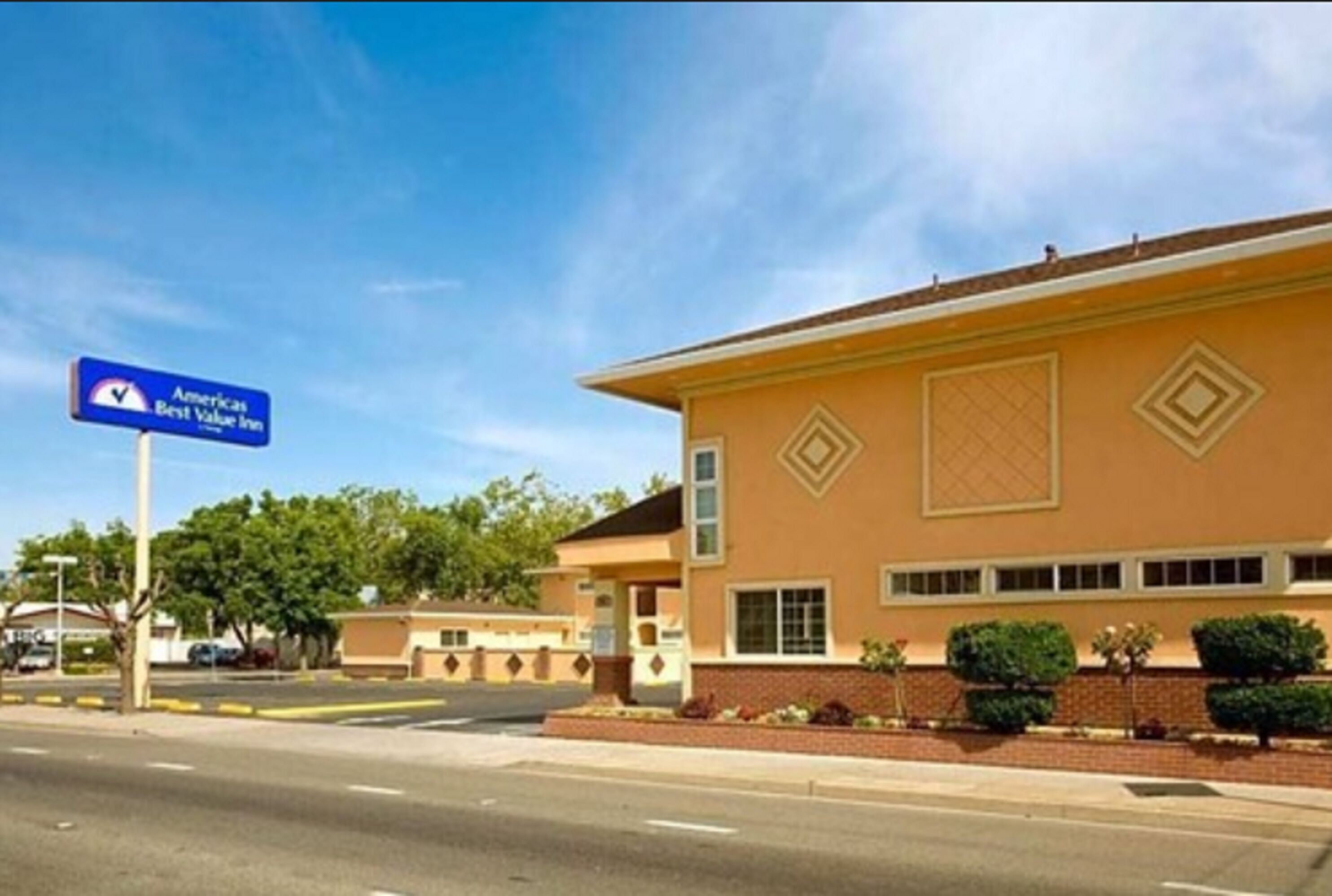 A two-story building with a sign for America Best Value Inn.