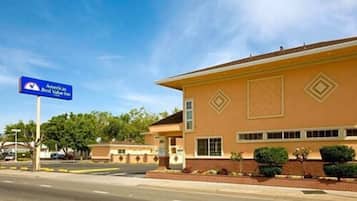 A two-story building with a sign for America Best Value Inn.