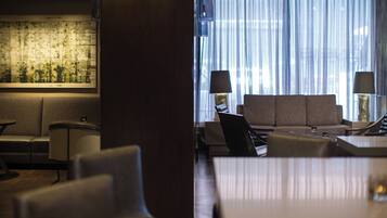 A modern hotel lobby with a sofa, chairs, and a table.