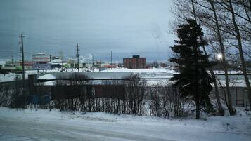Eine verschneite Landschaft mit einer Straße, Gebäuden und einem Schild für 'The Liquidation Centre'.