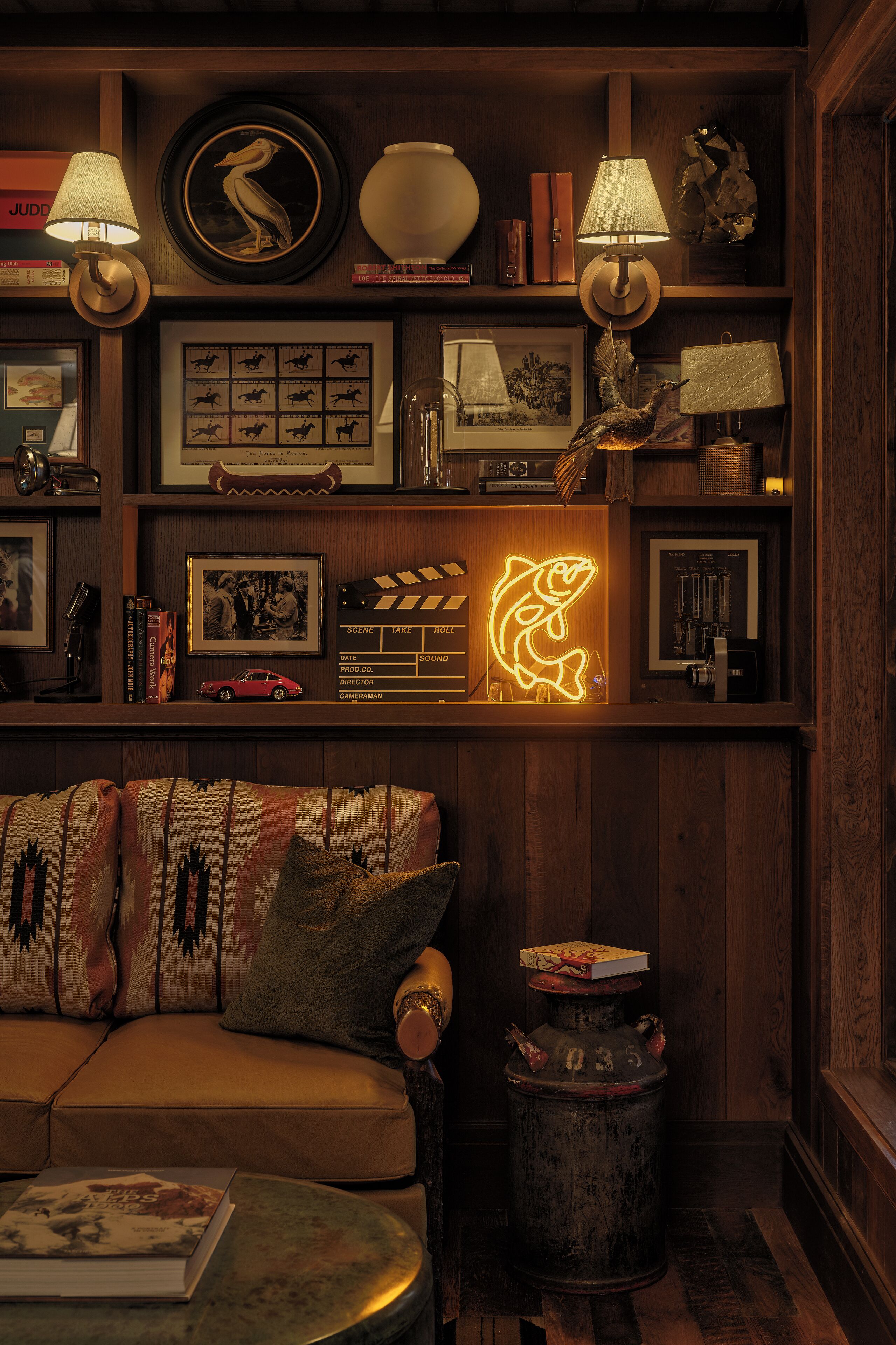 A cozy living room with a sofa, a coffee table, and a lamp.